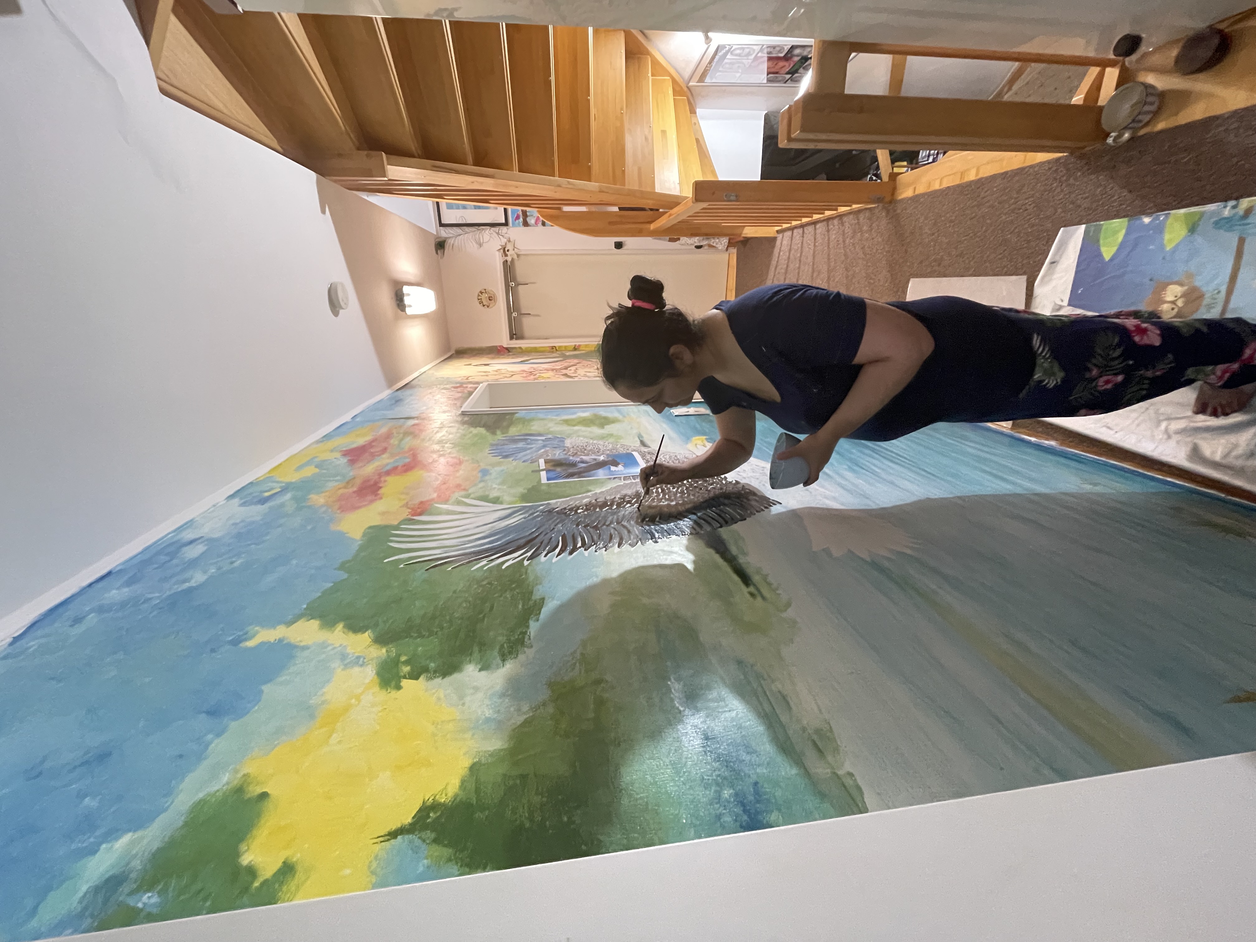 Sukhada painting the Air mural — smiling